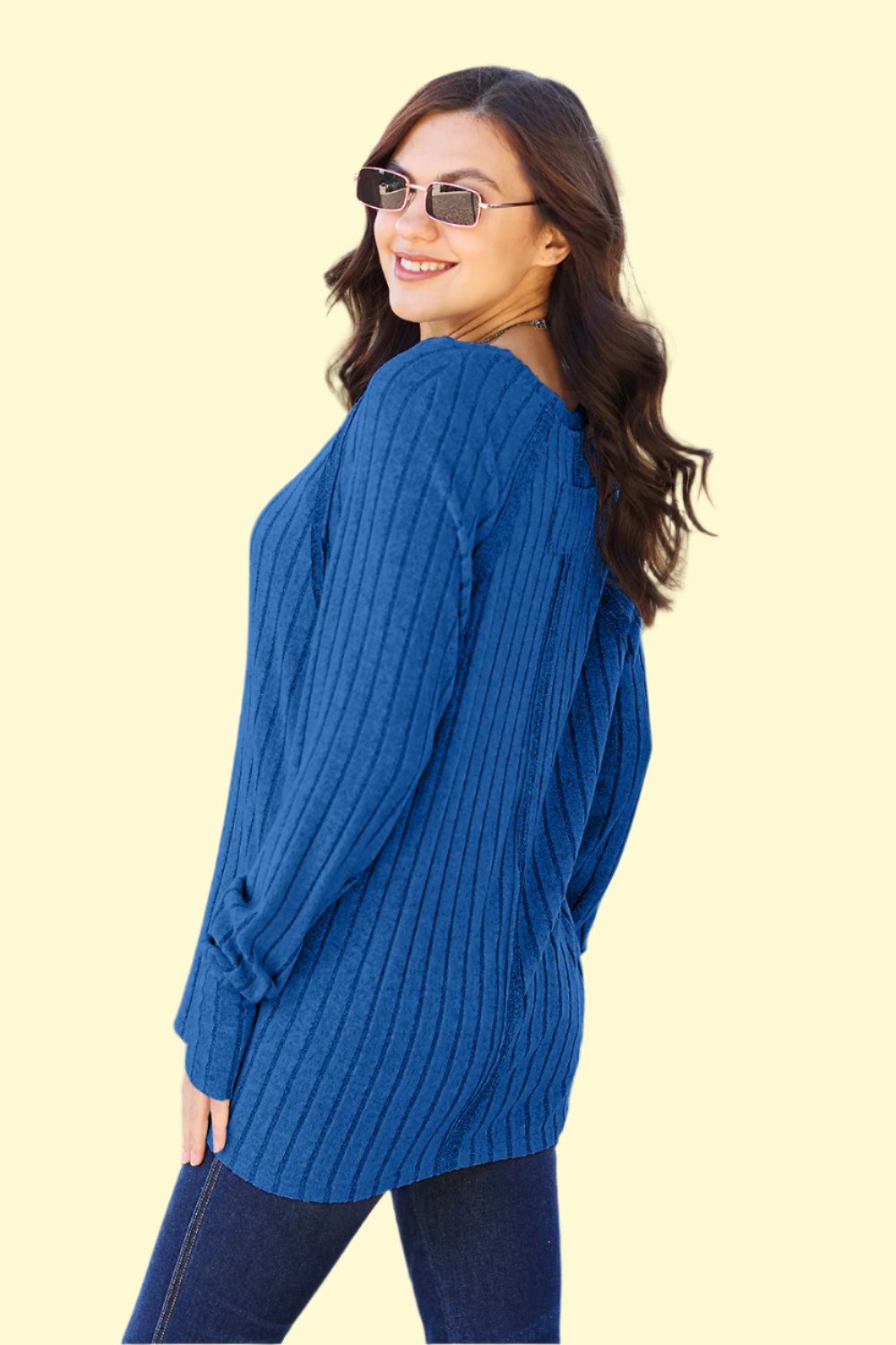 Model striking a pose in the royal blue knit top