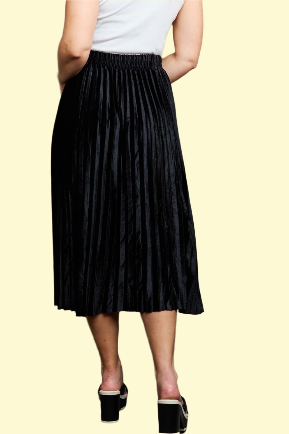 Back view of the model in the black midi skirt