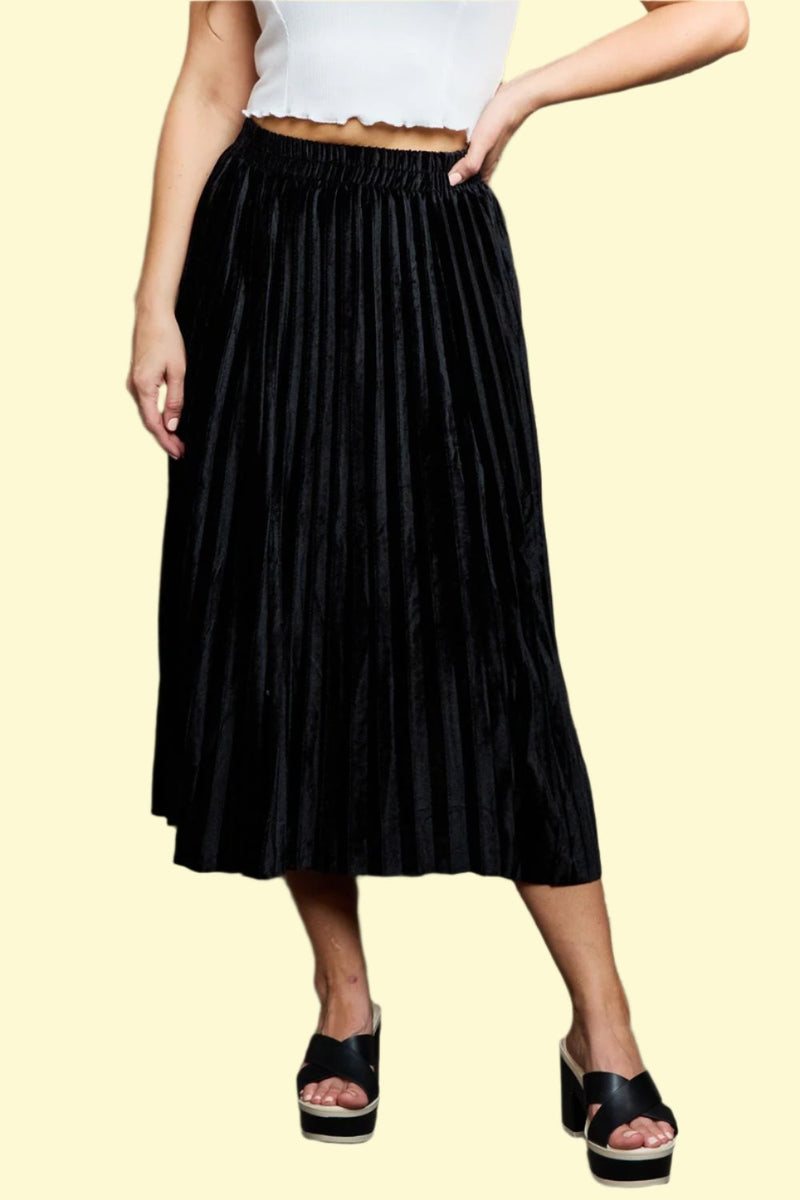 Model wearing a black flowy midi skirt