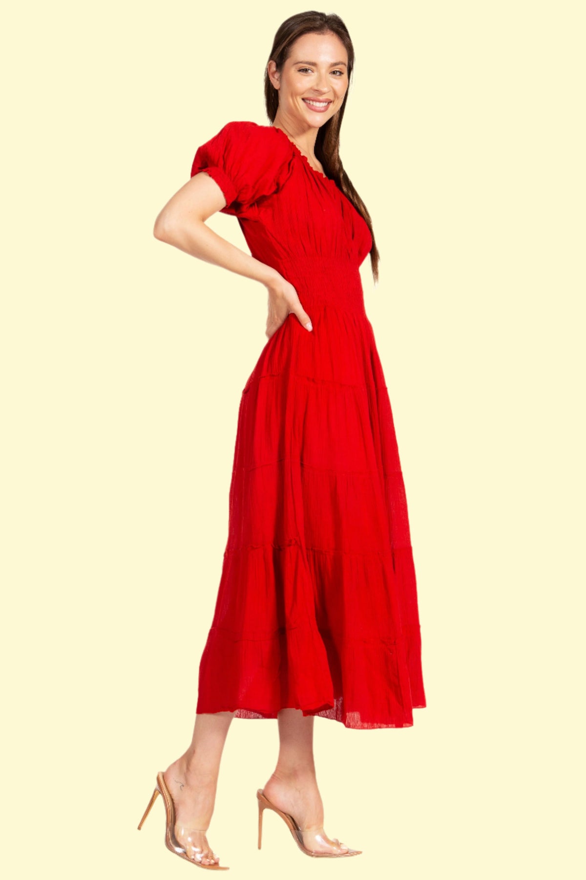 Model posing side view of red bohemian dress by West Closet