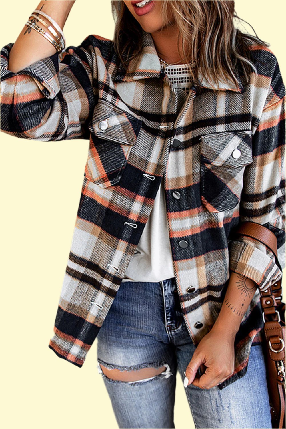 Model wearing a plaid shirt jacket in a studio